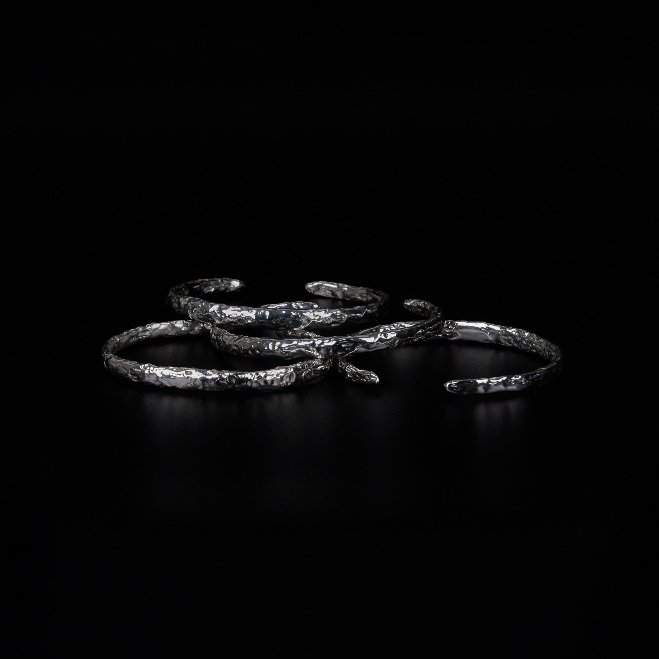 Multiple Distortion Cuff bracelets with hammered molten textures
