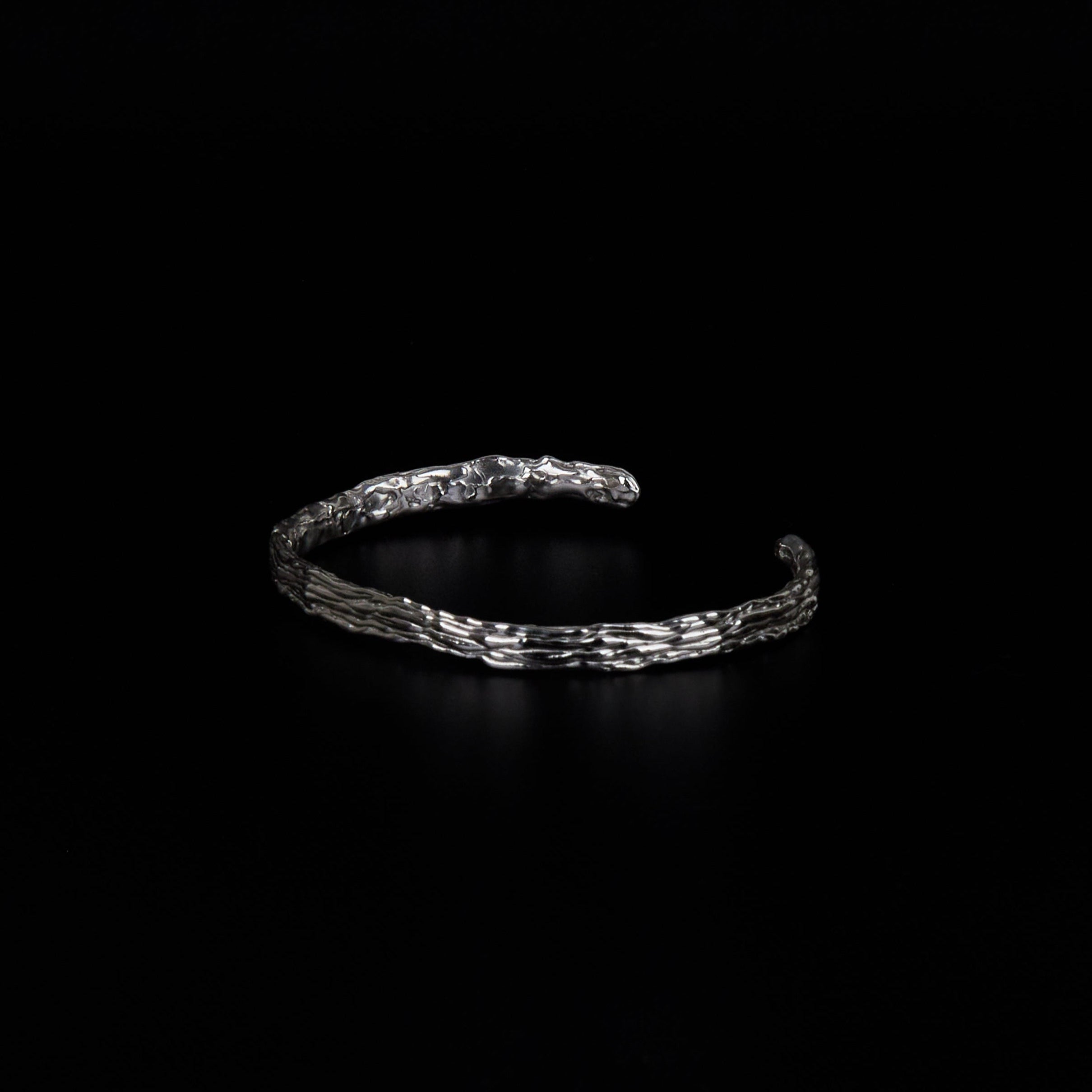 Polished silver cuff with fluid distorted surface